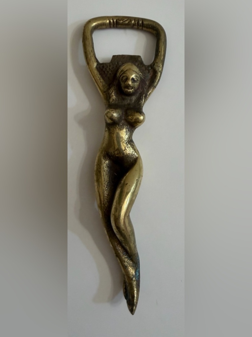 MidCentury brass bottle opener featuring sculptural female figure